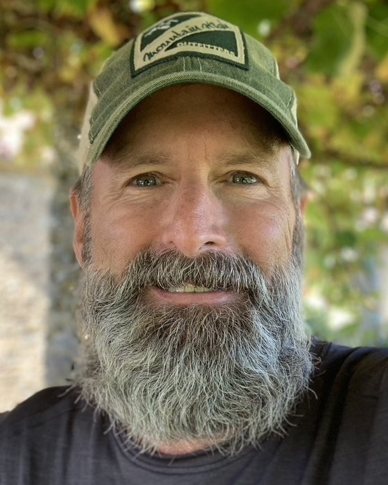 Gregg Phillips, founder of F3, smiling in a green ball cap