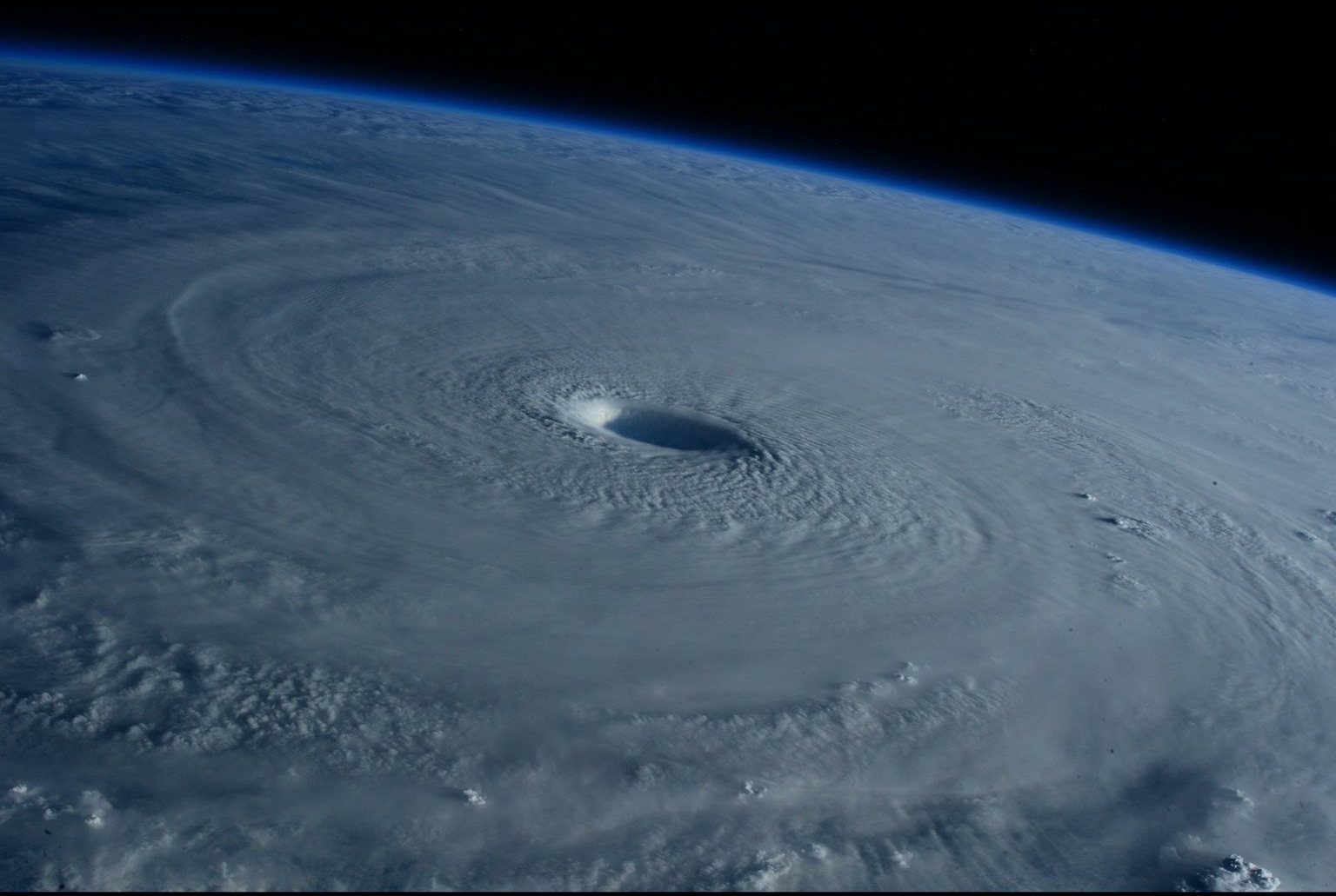 A hurricane seen from space, its eye wall spiraling over the ocean. Photo: NASA.